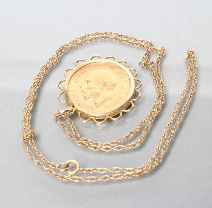 A GEORGE V SOVEREIGN 1911, in a 9ct gold loose pendant mount and 9ct gold rope twist chain necklace,