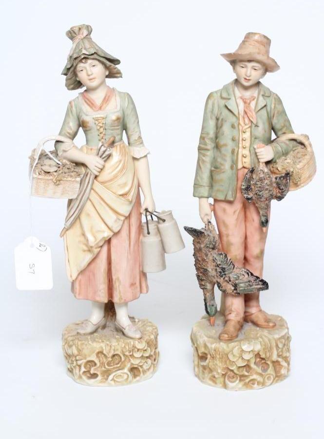 A PAIR OF ROYAL DUX FIGURES, early 20th century, modelled as a young hunter with a basket over his