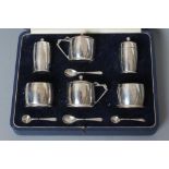 AN ART DECO SILVER SIX PIECE CRUET, maker Mappin & Webb, Birmingham 1934, of plain slightly bombe