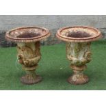 A PAIR OF VICTORIAN CAST IRON MEDICI STYLE URNS, the ovolo rim over a frieze of classical figures,