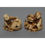 TWO JAPANESE IVORY NETSUKE, Meiji period, one carved as a child seated beneath a cracked egg, 1"