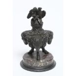 A FRENCH BRONZE INKWELL, 19th Century, adorned with three ram's heads on hoof feet, spaced by