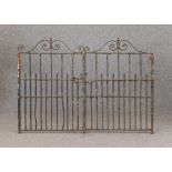 A MATCHED PAIR OF WROUGHT IRON GATES, c.1900(?), of multi barred form with acorn finials and