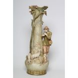 A LARGE ROYAL DUX FIGURAL VASE, early 20th century, the young piping shepherd standing with two
