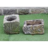 A SMALL SANDSTONE TROUGH of irregular rough hewn oblong form, 20" x 13 1/4" x 10 1/4", together with