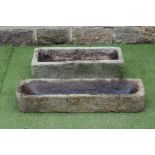 A SANDSTONE TROUGH of narrow oblong form, finely cut with rounded front corners, 40" x 11" x 65",