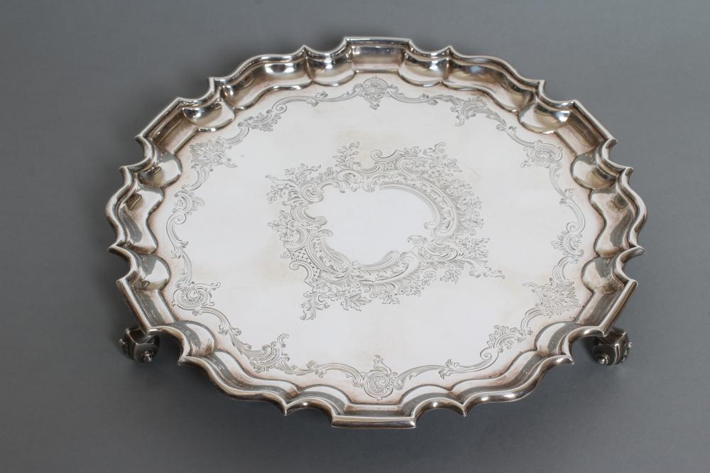 AN EDWARDIAN SILVER SALVER, maker Ackroyd Rhodes, London 1910, of shaped circular form with pie-