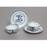 TWO NANKING CARGO PORCELAIN TEA BOWLS AND SAUCERS, painted in underglaze blue with pine trees,