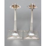 A PAIR OF ARTS AND CRAFTS SILVER CANDLESTICKS, maker Ackroyd Rhodes, London 1916, the deep dished