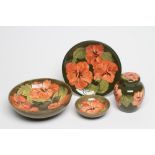 A COLLECTION OF MOORCROFT POTTERY, all tubelined and painted in orange with the Magnolia pattern