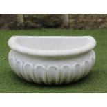 A CARRARA MARBLE WATER FONT of fluted demi-lune form with moulded rim, 19 1/4" x 12 1/4" x 8 1/2" (