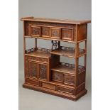 A THAI HARDWOOD SHODANA, modern, of open tiered form with stagwood shelving and cupboards, the