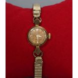A LADY'S 18K GOLD ROLEX ORCHID WRISTWATCH, the dark champagne dial with applied gilt batons,