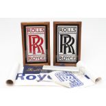 TWO FRAMED CERAMIC ROLLS ROYCE LOGOS, presumed to be part of a dealership's frontage, 15" x 9"