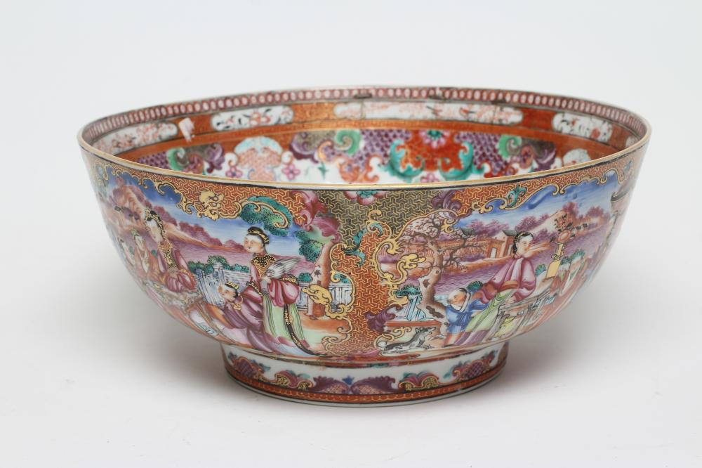 A CHINESE EXPORT PORCELAIN PUNCH BOWL painted in famille rose enamels with panels of figures,