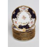 A SET OF TWELVE COALPORT CHINA DESSERT PLATES, early 20th century, printed and painted with the "