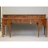 A SCOTTISH GEORGIAN MAHOGANY STAGE BACK SIDEBOARD, c.1800, of mildly bowed form, the banded