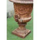 A VICTORIAN CAST IRON URN of half fluted campana form with beaded rim and mask loop handles, the