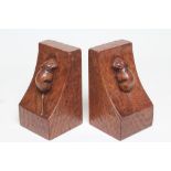 A PAIR OF ROBERT THOMPSON ADZED OAK BOOKENDS of square form, the dished side with carved mouse