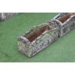 A PAIR OF "WILLOWSTONE" CAST PLANTERS of oblong form with arched trellis patterned sides, 24" x 9