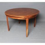 A DANISH DYRLAND TEAK EXTENDING DINING TABLE, 1960/70's, the circular top with patent fold out