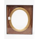 A VICTORIAN GILT WOOD OVAL FRAME, the cushion frame moulded with a band of foliate scrolls set in