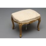 A LOUIS XVI STYLE GILT WOOD DRESSING STOOL, c.1900, the oblong overstuffed seat in champagne damask,