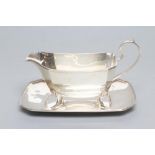AN ART DECO SAUCE BOAT AND STAND, maker Roberts & Dove, Birmingham 1932, of plain canted oblong form