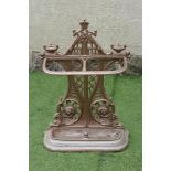 A VICTORIAN CAST IRON STICK STAND, the arched and waisted back pierced with trellis and foliate