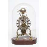 A BRASS GOTHIC STYLE SKELETON CLOCK, the fusee movement with pierced silvered chapter ring with