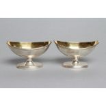 A PAIR OF GEORGE III PEDESTAL SALTS, maker R & T Makepeace, London 1793, of plain oval form with