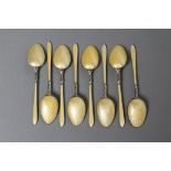 A SET OF EIGHT ART DECO GILT COFFEE SPOONS, maker's mark S. Ld., Birmingham 1929, with primrose