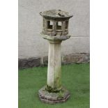A COMPOSITION STONE BIRD FEEDER, of octagonal form, the Oriental style lantern top with arcaded