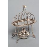 A TOASTRACK ON STAND WITH BURNER, maker Asprey, Birmingham 1911, the oval section seven bar wirework