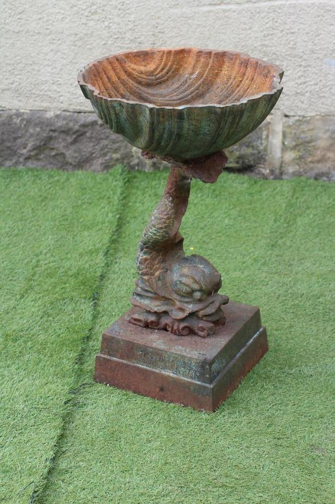 A CAST IRON PLANTER modelled as a dolphin supporting a scallop shell, raised on moulded square base,