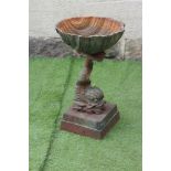 A CAST IRON PLANTER modelled as a dolphin supporting a scallop shell, raised on moulded square base,