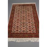 A PERSIAN RUG, modern, the ivory field with all over Herati style repeating floral pattern in shades