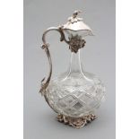 A HEAVY GLASS SHAFT AND GLOBE WINE EWER with panelled neck, the diamond cut body with fruiting