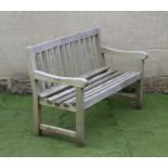 A TEAK BENCH, modern, the slatted back with straight top rail, slatted seat, mildly scrolled arm