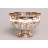 A LATE VICTORIAN ROSE BOWL, maker's mark HA, Sheffield 1897, of semi lobed form on low swept foot