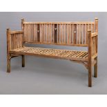 AN ARTS AND CRAFTS STYLE TEAK BENCH, the slatted back with straight top rail and pierced with