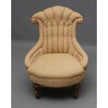 A VICTORIAN WALNUT FRAMED NURSING CHAIR button upholstered in a cream, green and rust weave, the