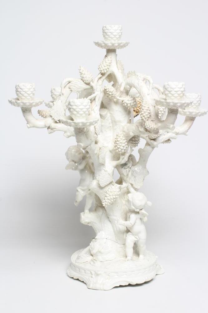 A LARGE VICTORIAN MOORE BROS. WHITE GLAZED CANDELABRUM, modelled as three cherubs climbing a fir