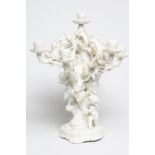 A LARGE VICTORIAN MOORE BROS. WHITE GLAZED CANDELABRUM, modelled as three cherubs climbing a fir