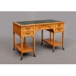 AN EDWARDIAN SATINWOOD DESK, the moulded oblong top inset with green leather, frieze drawer below