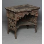 AN INDIAN KASHMIRE MERCHANT'S HARDWOOD KNEEHOLE DESK of oblong form profusely carved in high and low