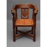 A RARE ROBERT THOMPSON ADZED OAK MONKS CHAIR, c.1930, the bow rail with scrolled ends on turned