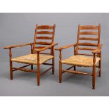 A PAIR OF GORDON RUSSELL ARTS AND CRAFTS STYLE FRUITWOOD ARMCHAIRS, c.1900, the adjustable ladder