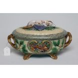 A VICTORIAN MINTON MAJOLICA GAME PIE DISH AND COVER of oval basket weave form with naturalistic