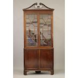 A GEORGIAN MAHOGANY STANDING CORNER CUPBOARD, third quarter 18th century, the moulded and dentil